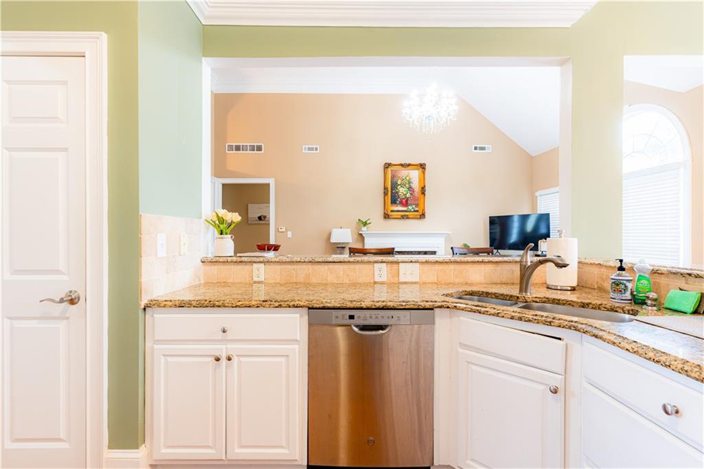 8105 Jot Em Down Road Gainesville, GA 30506 - Photo 26 of 73 a bathroom with a granite countertop sink and a mirror