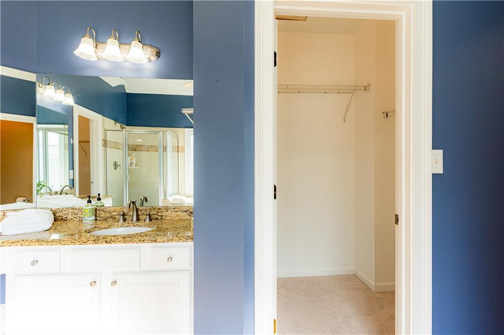 8105 Jot Em Down Road Gainesville, GA 30506 - Photo 36 of 73 a bathroom with a sink and a mirror