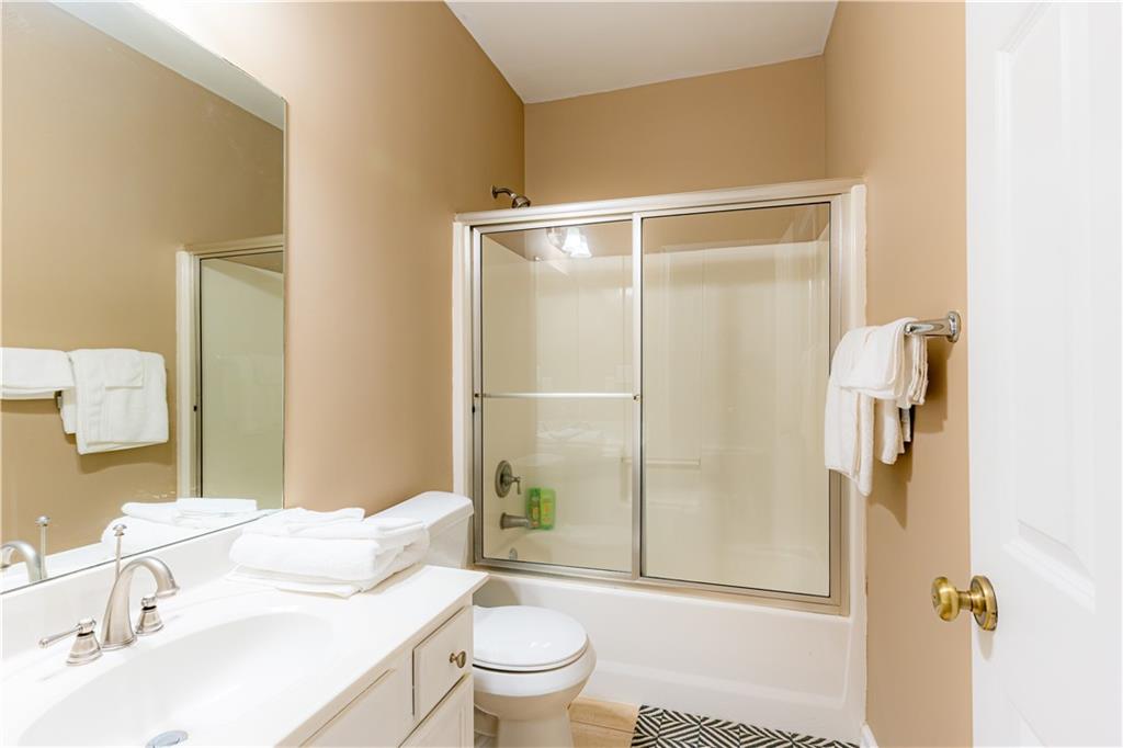 8105 Jot Em Down Road Gainesville, GA 30506 - Photo 43 of 73 a bathroom with a sink toilet and shower