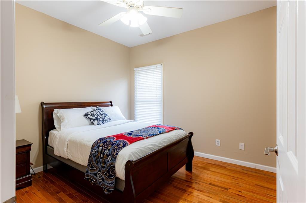 8105 Jot Em Down Road Gainesville, GA 30506 - Photo 44 of 73 a bedroom with a bed and wooden floor