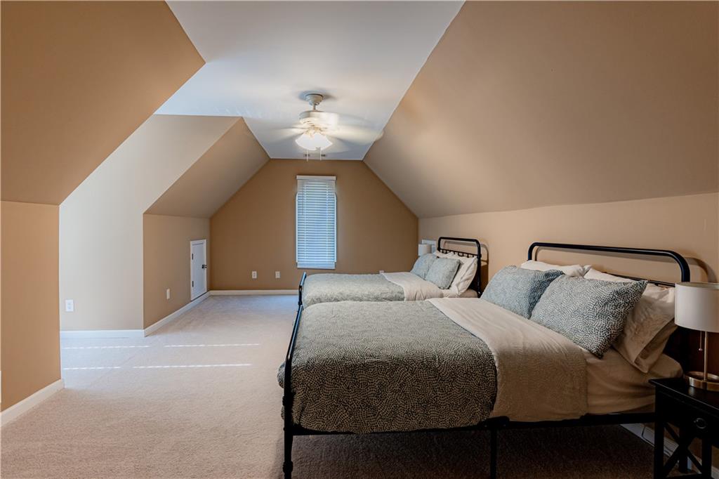 8105 Jot Em Down Road Gainesville, GA 30506 - Photo 49 of 73 a bedroom with a bed and a chandelier