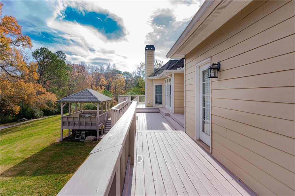 8105 Jot Em Down Road Gainesville, GA 30506 - Photo 59 of 73 a view of a house with backyard and deck