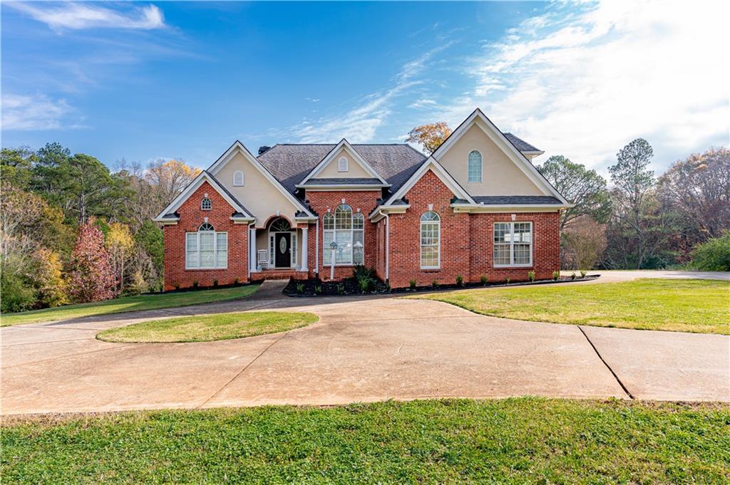 8105 Jot Em Down Road Gainesville, GA 30506 - Photo 6 of 73 a front view of a house with a yard and garage