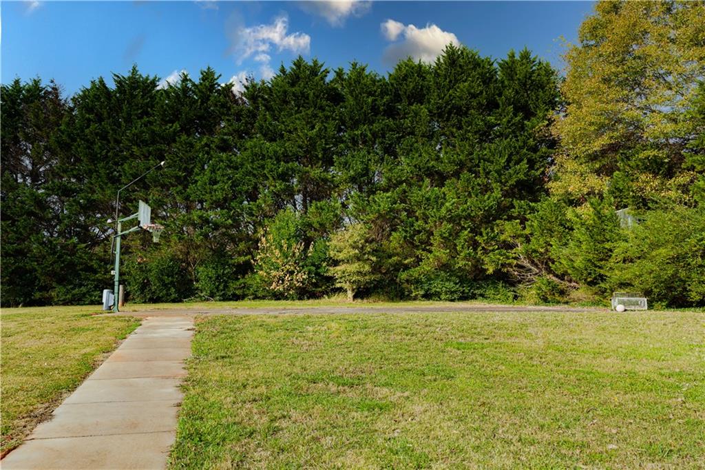 8105 Jot Em Down Road Gainesville, GA 30506 - Photo 9 of 73 a view of a yard with a trees