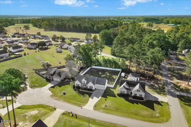 an aerial view of a house with outdoor space
