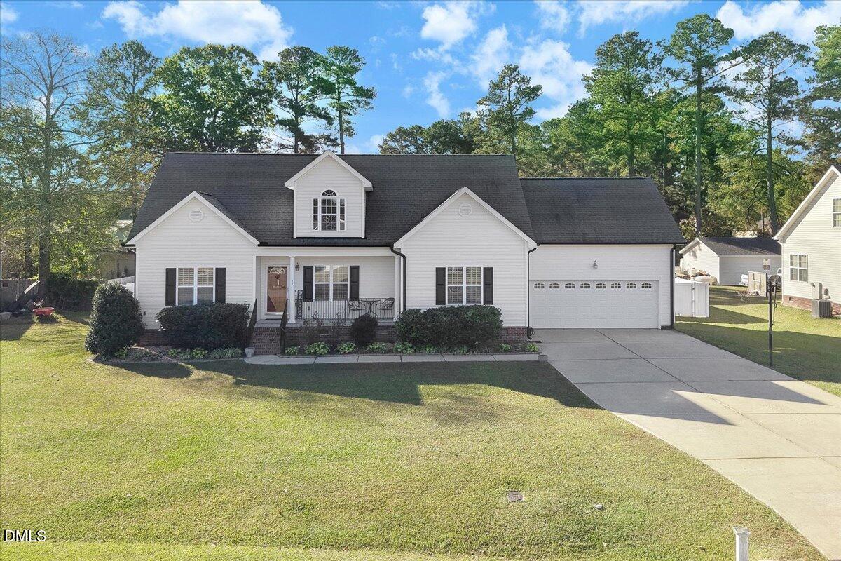 22 Quebec Drive Selma, NC 27576 - Photo 19 of 39 a front view of a house with a yard