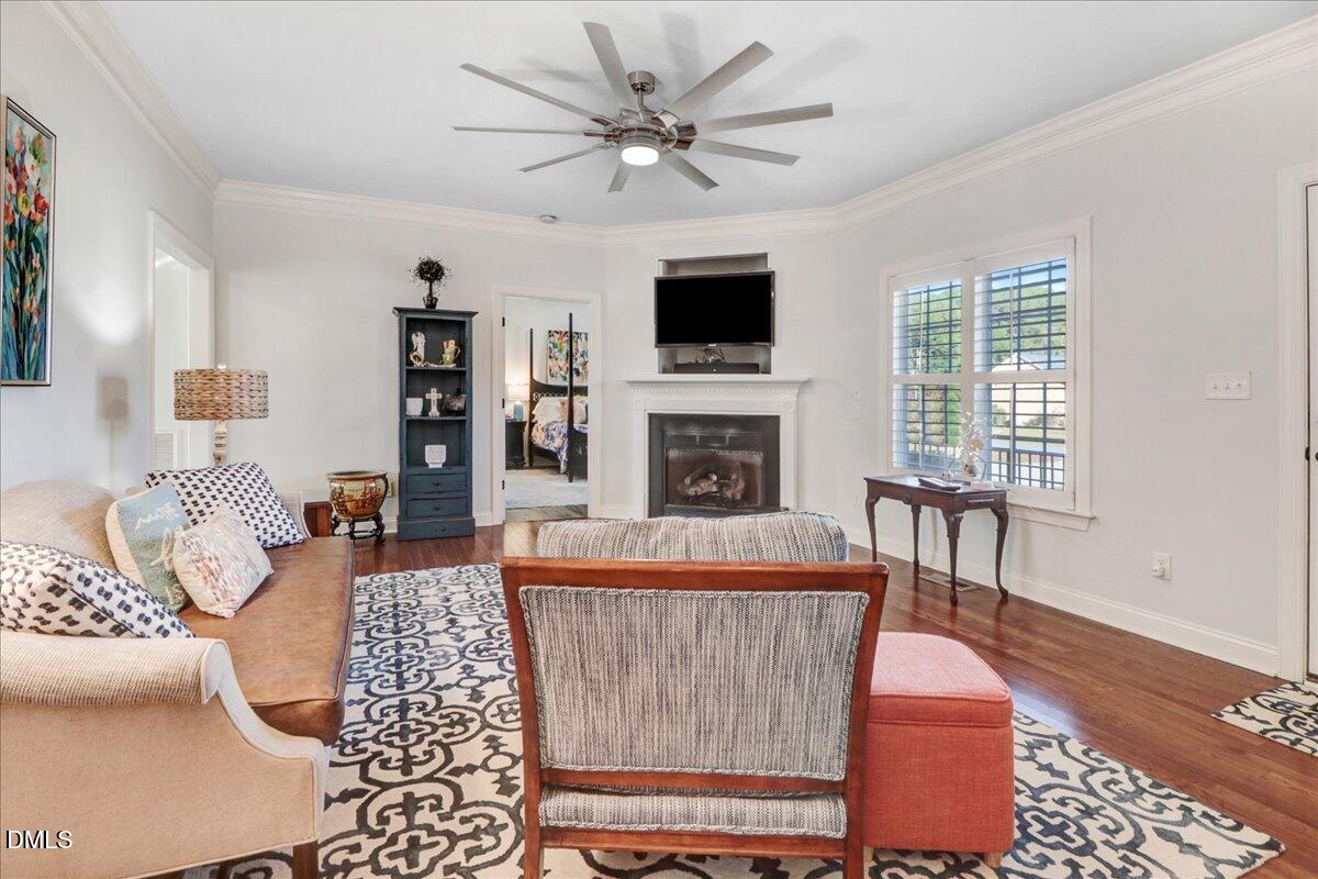 22 Quebec Drive Selma, NC 27576 - Photo 22 of 39 a living room with furniture a fireplace and a flat screen tv