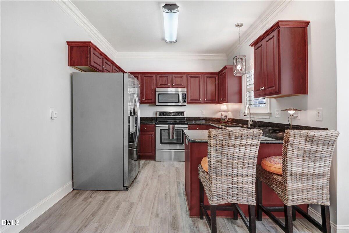 22 Quebec Drive Selma, NC 27576 - Photo 27 of 39 a kitchen with stainless steel appliances granite countertop a refrigerator and a stove top oven