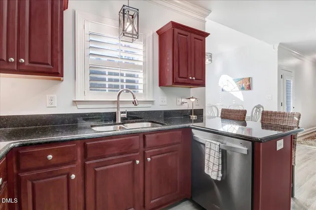 a kitchen with stainless steel appliances granite countertop a sink and a refrigerator