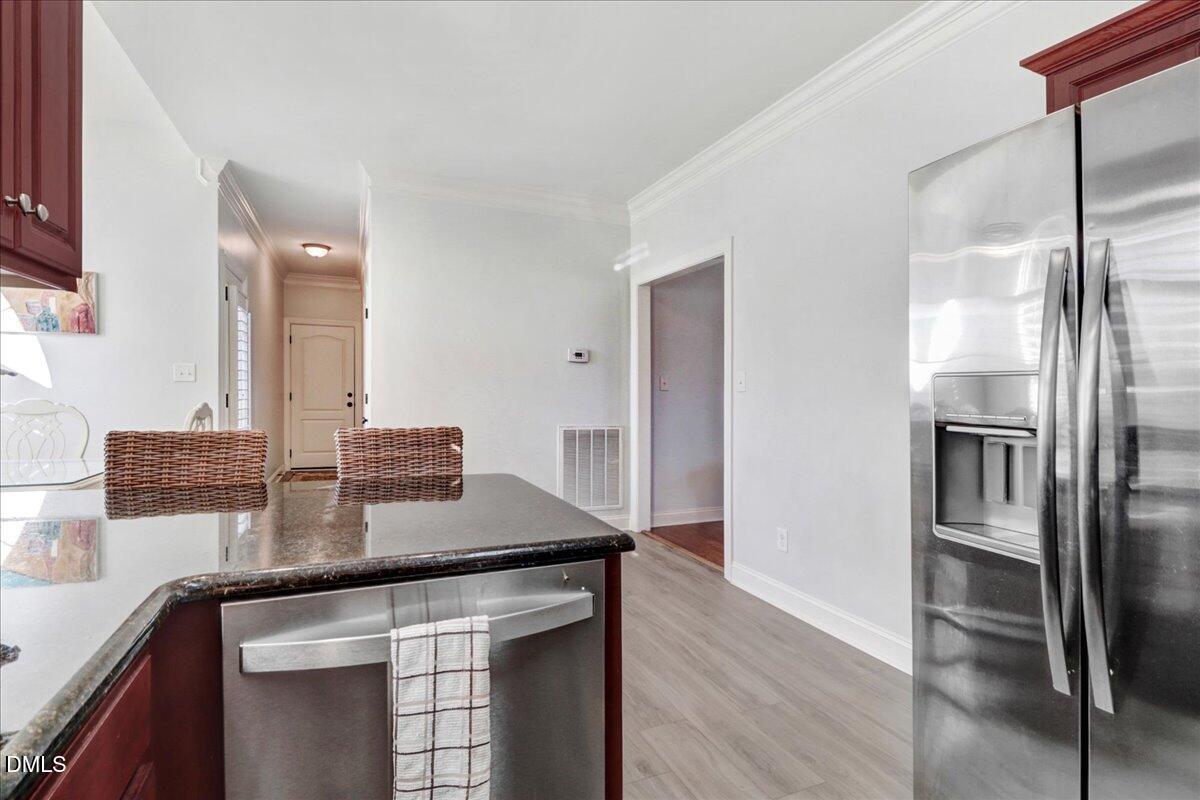 22 Quebec Drive Selma, NC 27576 - Photo 30 of 39 a kitchen with stainless steel appliances granite countertop a sink and a refrigerator