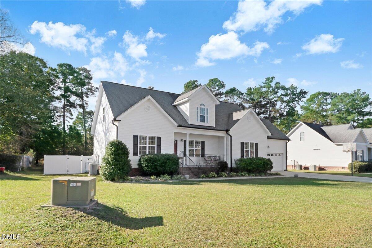 22 Quebec Drive Selma, NC 27576 - Photo 3 of 39 a front view of a house with swimming pool having outdoor seating