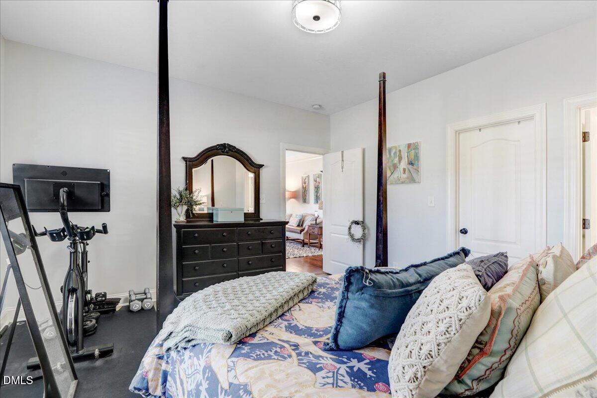 22 Quebec Drive Selma, NC 27576 - Photo 32 of 39 a bedroom with a bed and a flat screen tv on the dresser