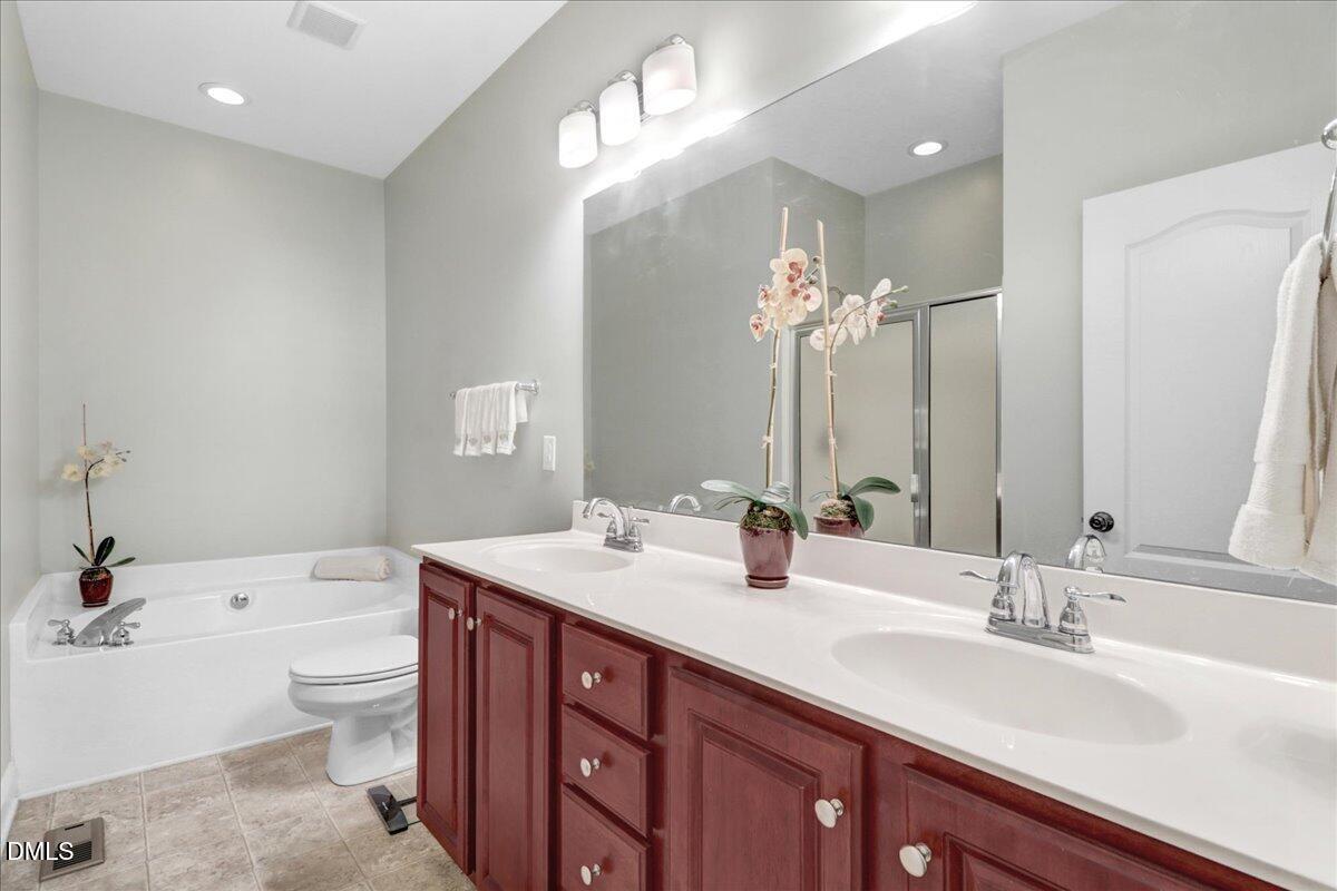 22 Quebec Drive Selma, NC 27576 - Photo 33 of 39 a bathroom with a double vanity sink toilet and a mirror