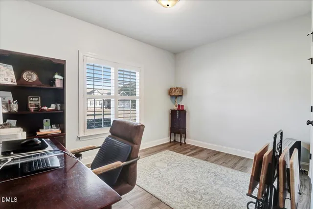 a view of a workspace with furniture and a window