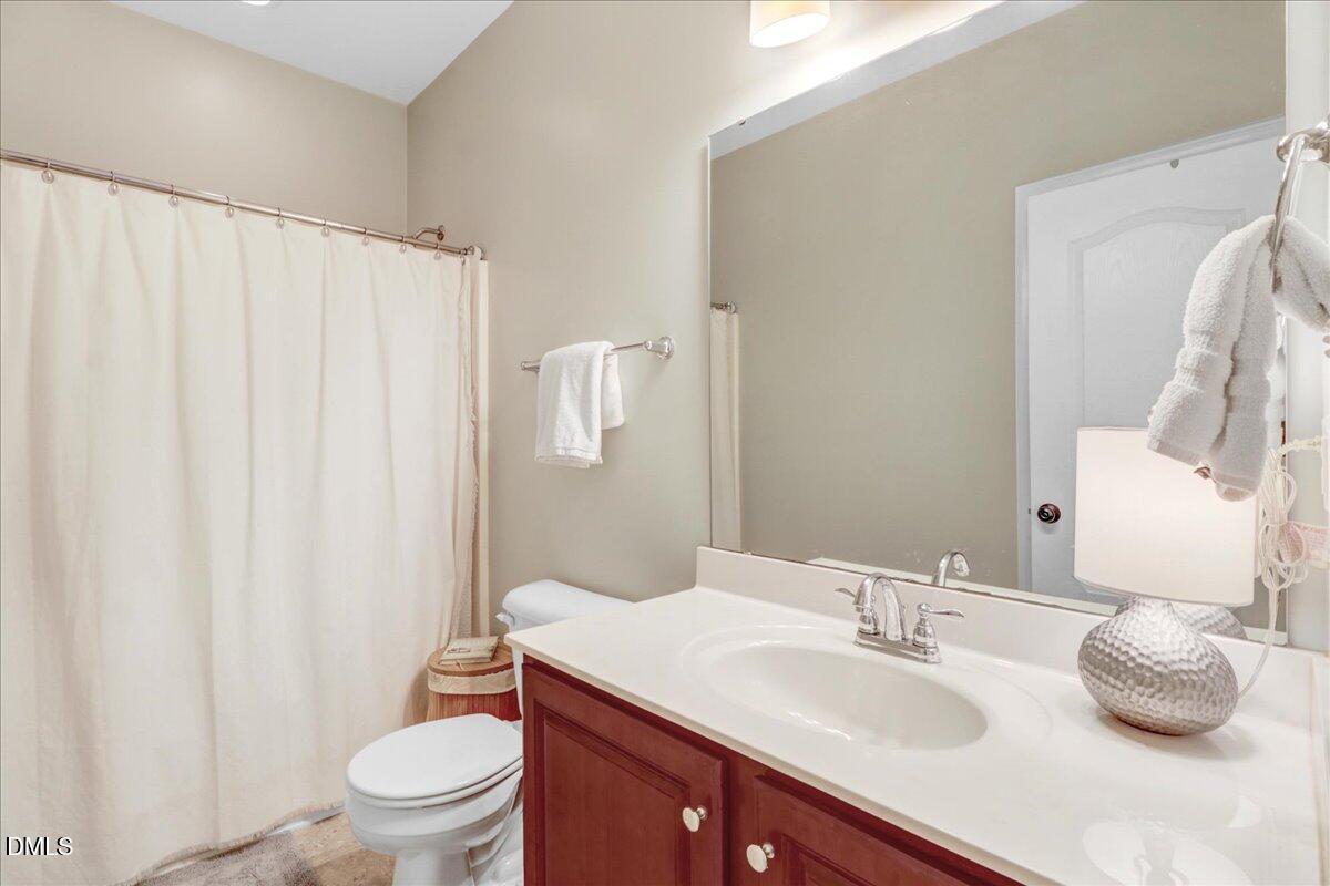 22 Quebec Drive Selma, NC 27576 - Photo 38 of 39 a bathroom with a granite countertop sink and a mirror