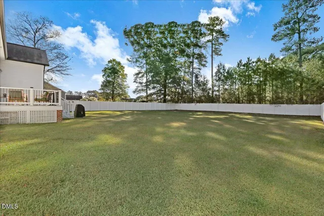 a view of a deck with furniture and garden