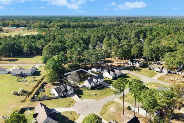 an aerial view of a house with a swimming pool yard and outdoor seating