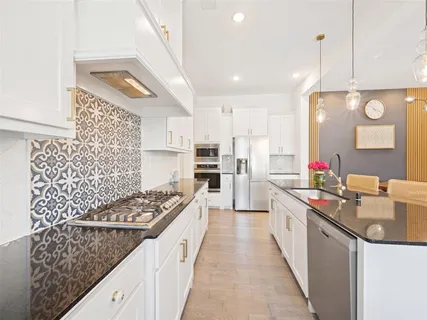 a kitchen with a stove and a sink