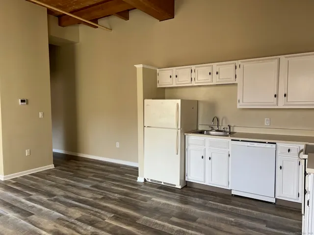 a kitchen with white cabinets and white appliances