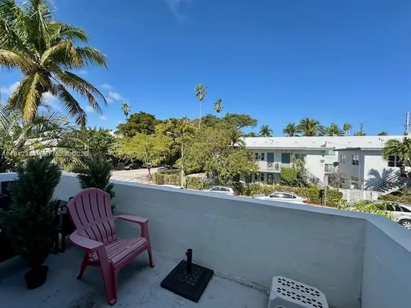 a view of a balcony with chairs