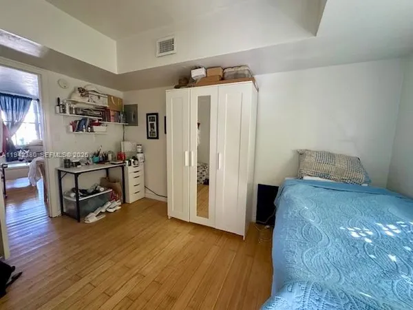 a bedroom with bed and cabinets