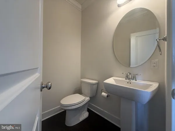 a bathroom with a sink toilet and a mirror