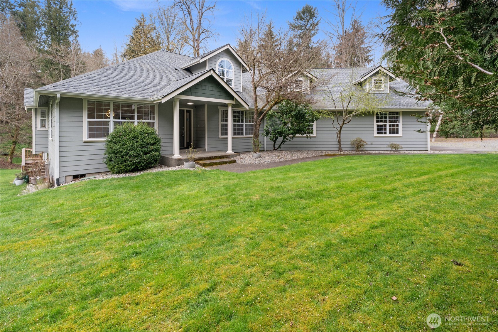3841 Mari Lane Southeast Olympia, WA 98513 - Photo 1 of 40 a front view of a house with a yard and trees