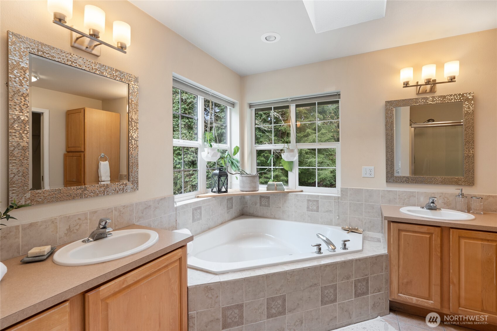 3841 Mari Lane Southeast Olympia, WA 98513 - Photo 18 of 40 a bathroom with a tub double sink window and mirror