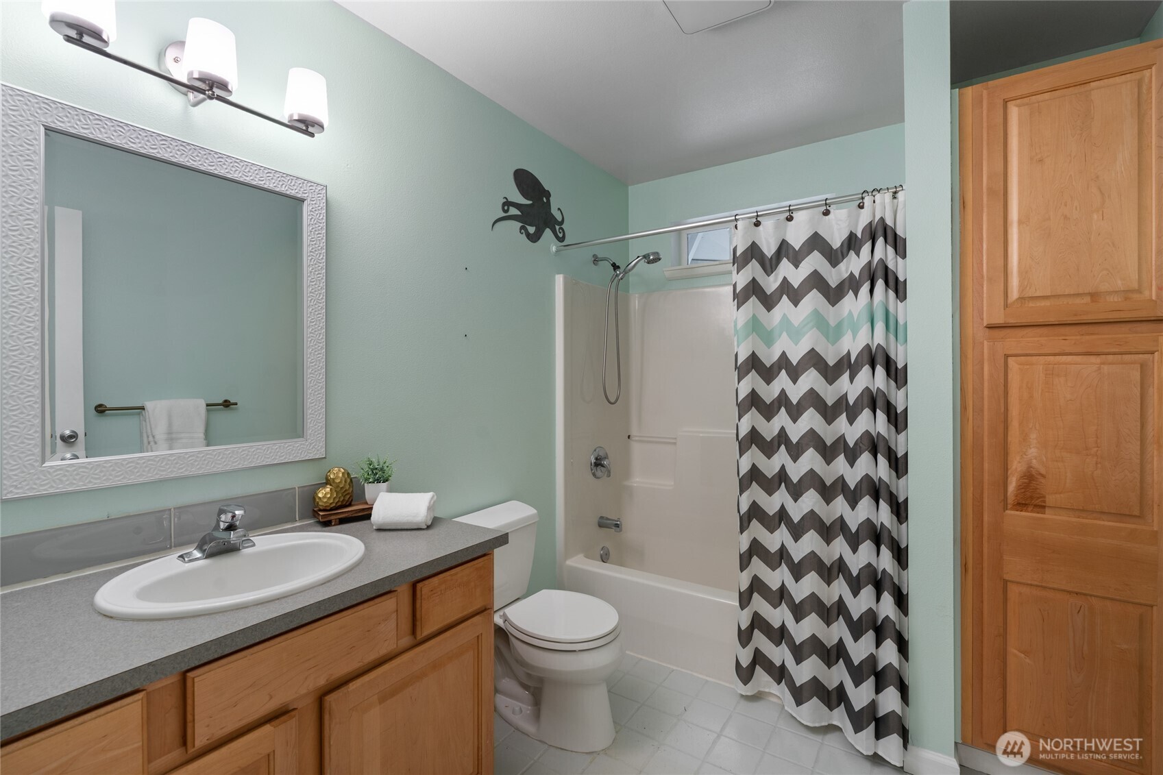 3841 Mari Lane Southeast Olympia, WA 98513 - Photo 21 of 40 a bathroom with a sink a toilet and shower curtain