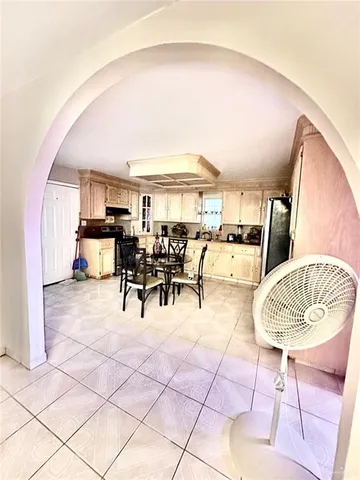 a dining room with furniture and a kitchen view