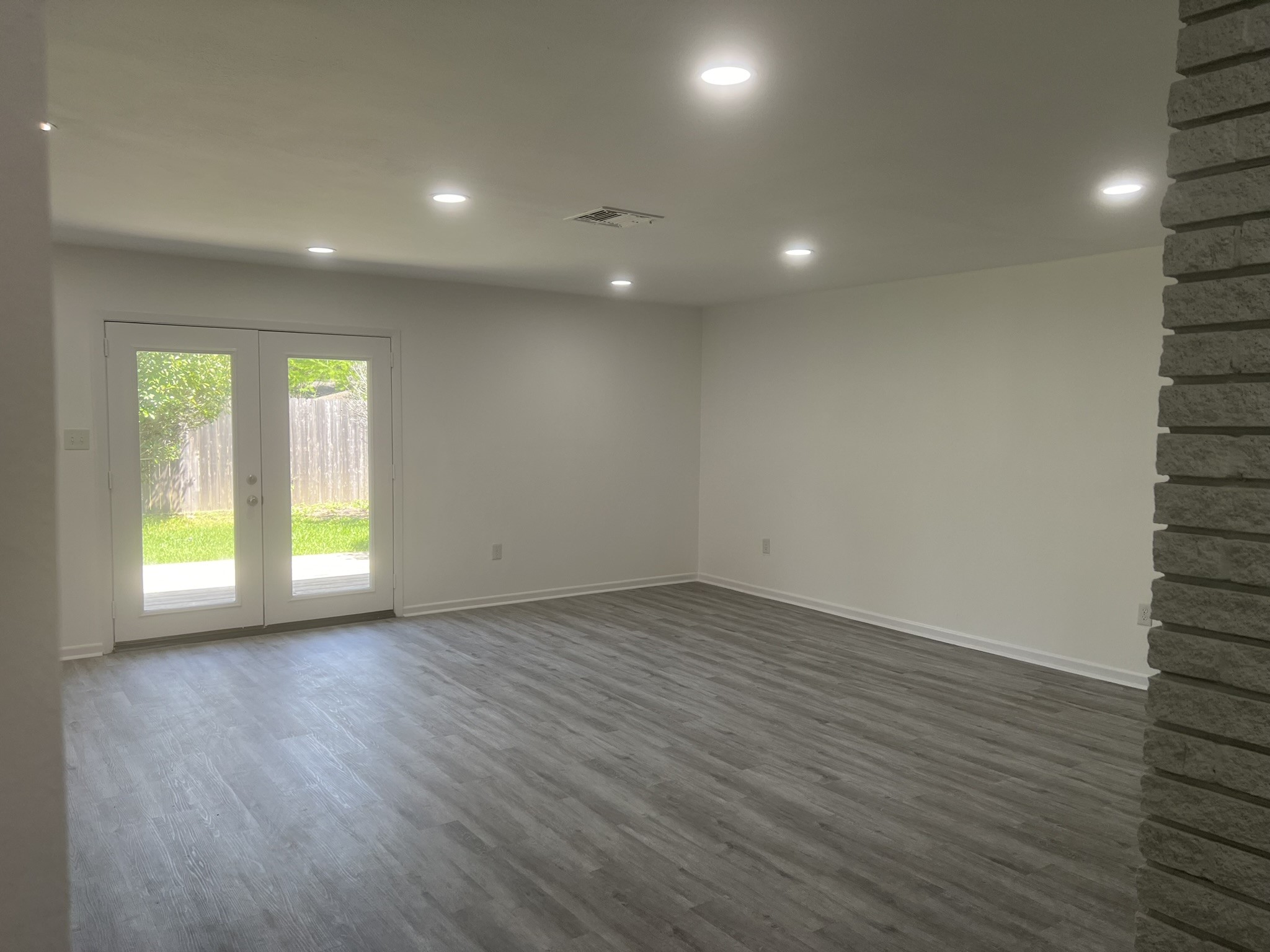 9007 Dunlap Street Houston, TX 77074 - Photo 21 of 22 Living room- HUGE with BEW lighting, floors and accent wall. OPEN CONCEPT floor plan.