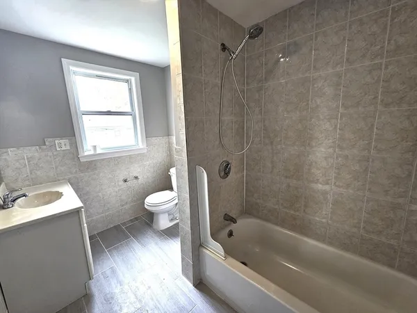 a bathroom with a sink a toilet and a bathtub