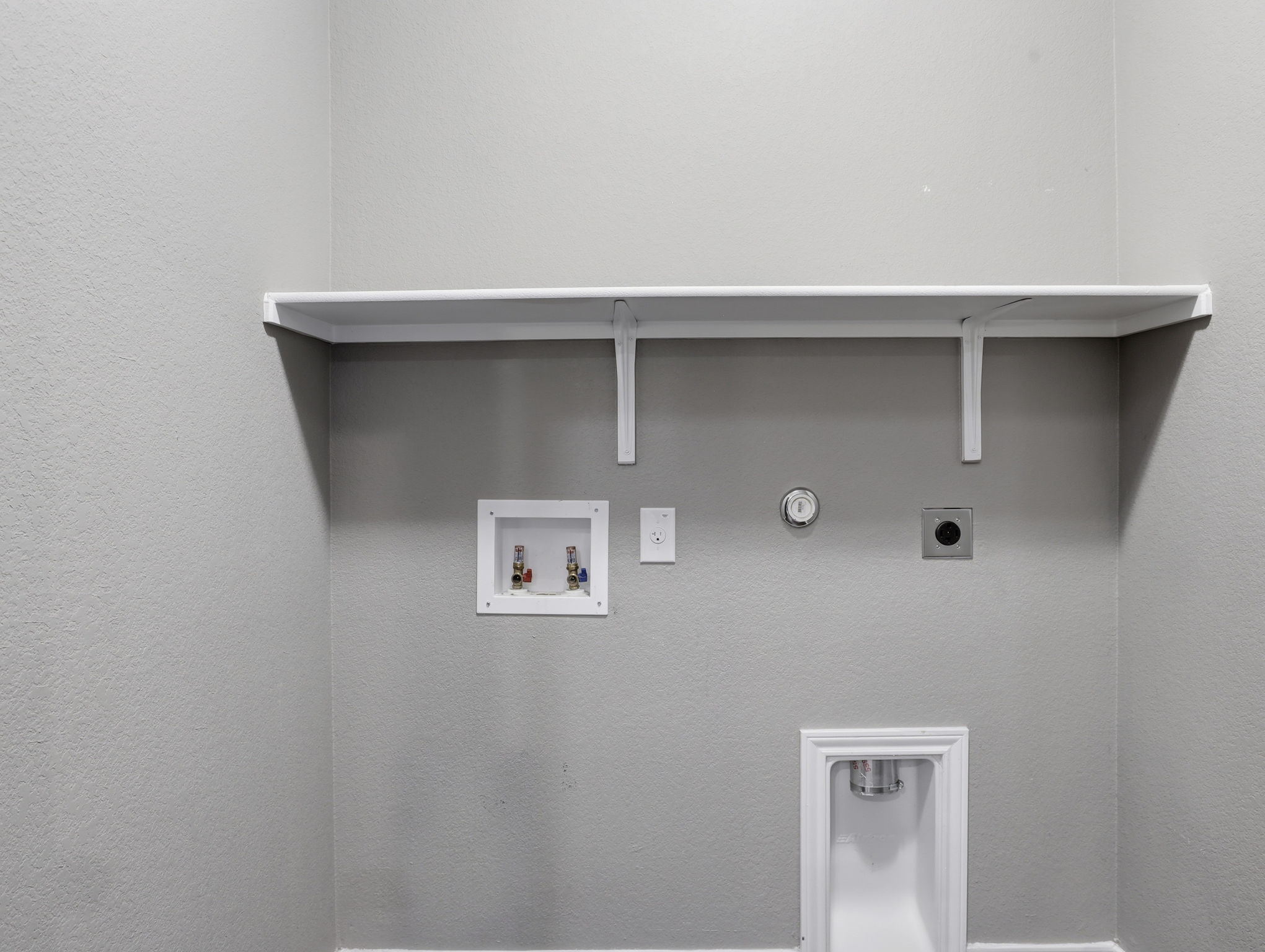 640 Landon Samuel Loop Pflugerville, TX 78660 - Photo 27 of 33 Dedicated laundry area featuring a built-in white shelf, washing machine hookups, and a dryer vent
