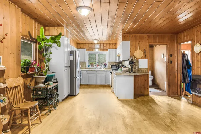 a kitchen with stainless steel appliances a refrigerator sink and cabinets