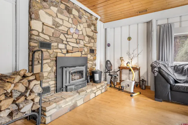 a bedroom with a bed and a potted plant on the dresser