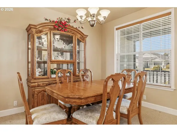 a view of a dining room with furniture and window