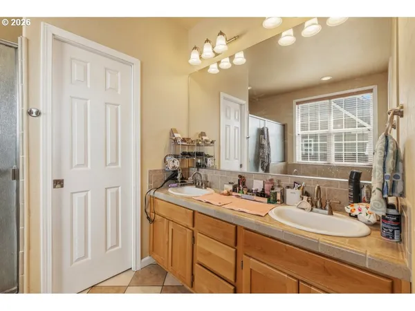 a bathroom with a sink vanity granite and a mirror