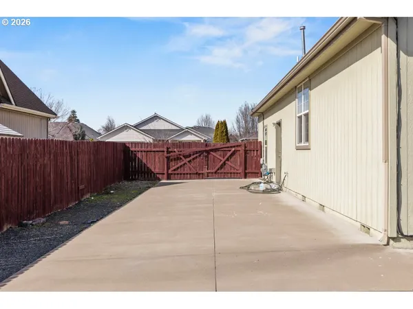 a view of a house with wooden fence