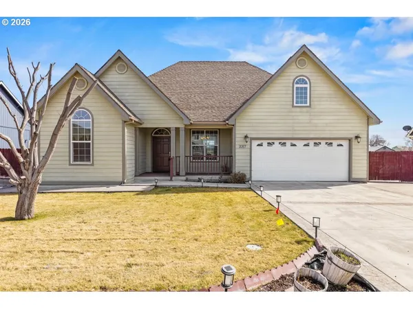 a view of a house with a door and wooden bench