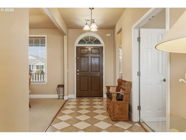 a view of a hallway with wooden floor and a living room