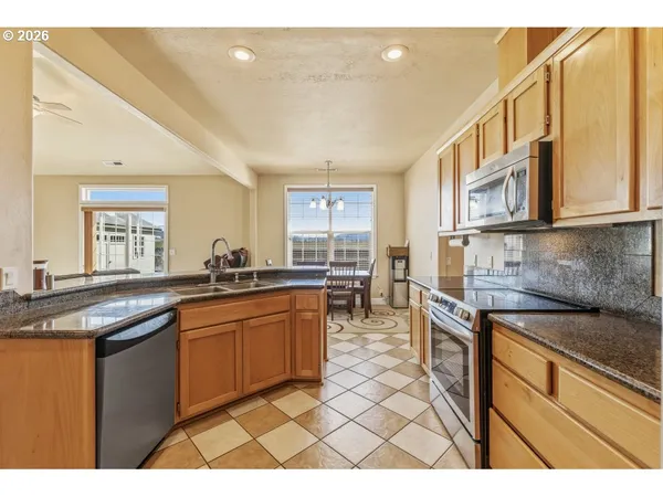 a kitchen with stainless steel appliances granite countertop a sink and cabinets