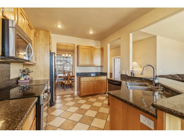 a kitchen with granite countertop a sink and cabinets