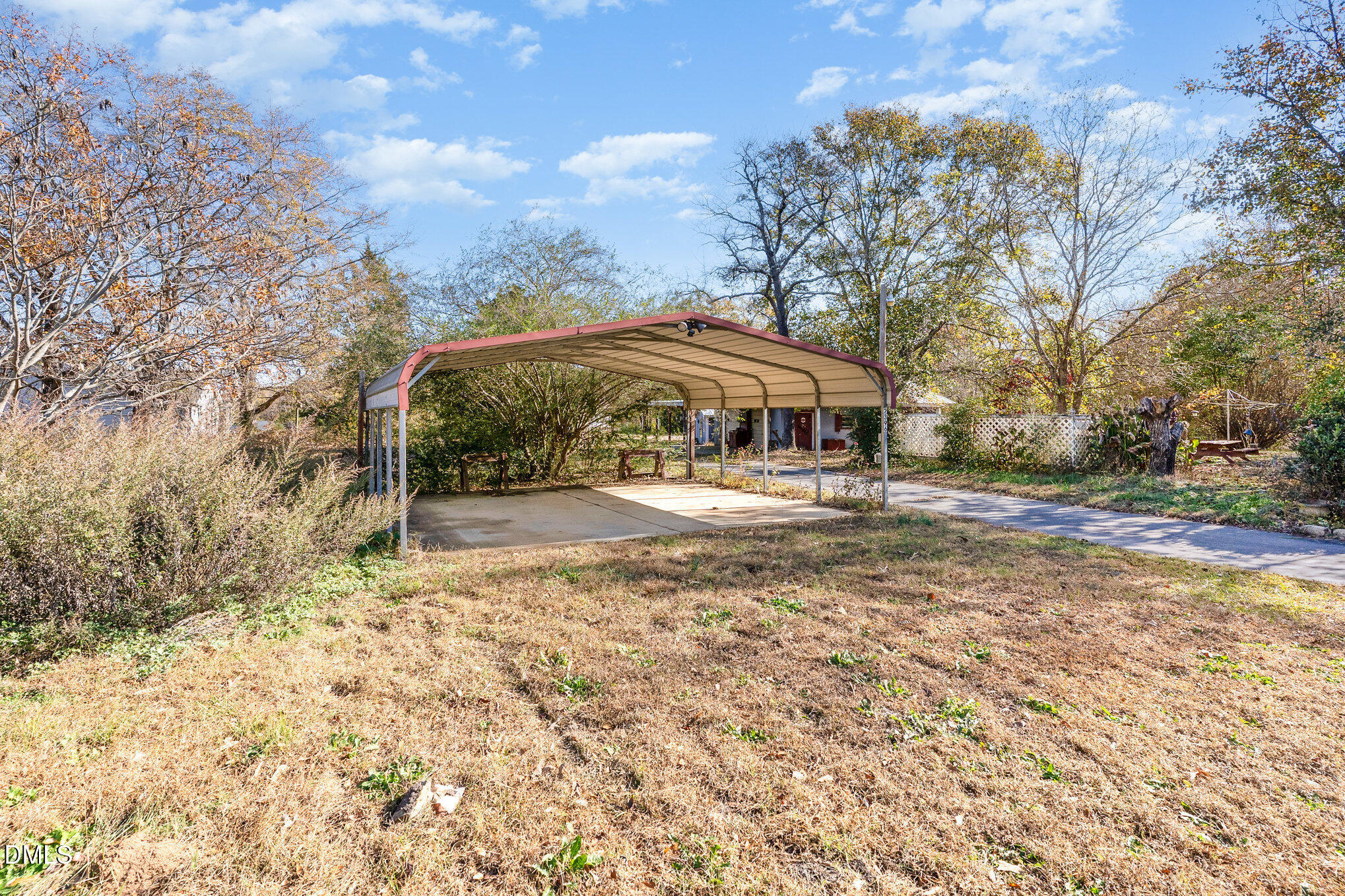 2396 Mitchell Road Angier, NC 27501 - Photo 20 of 21 a backyard of a house with table and chairs under an umbrella