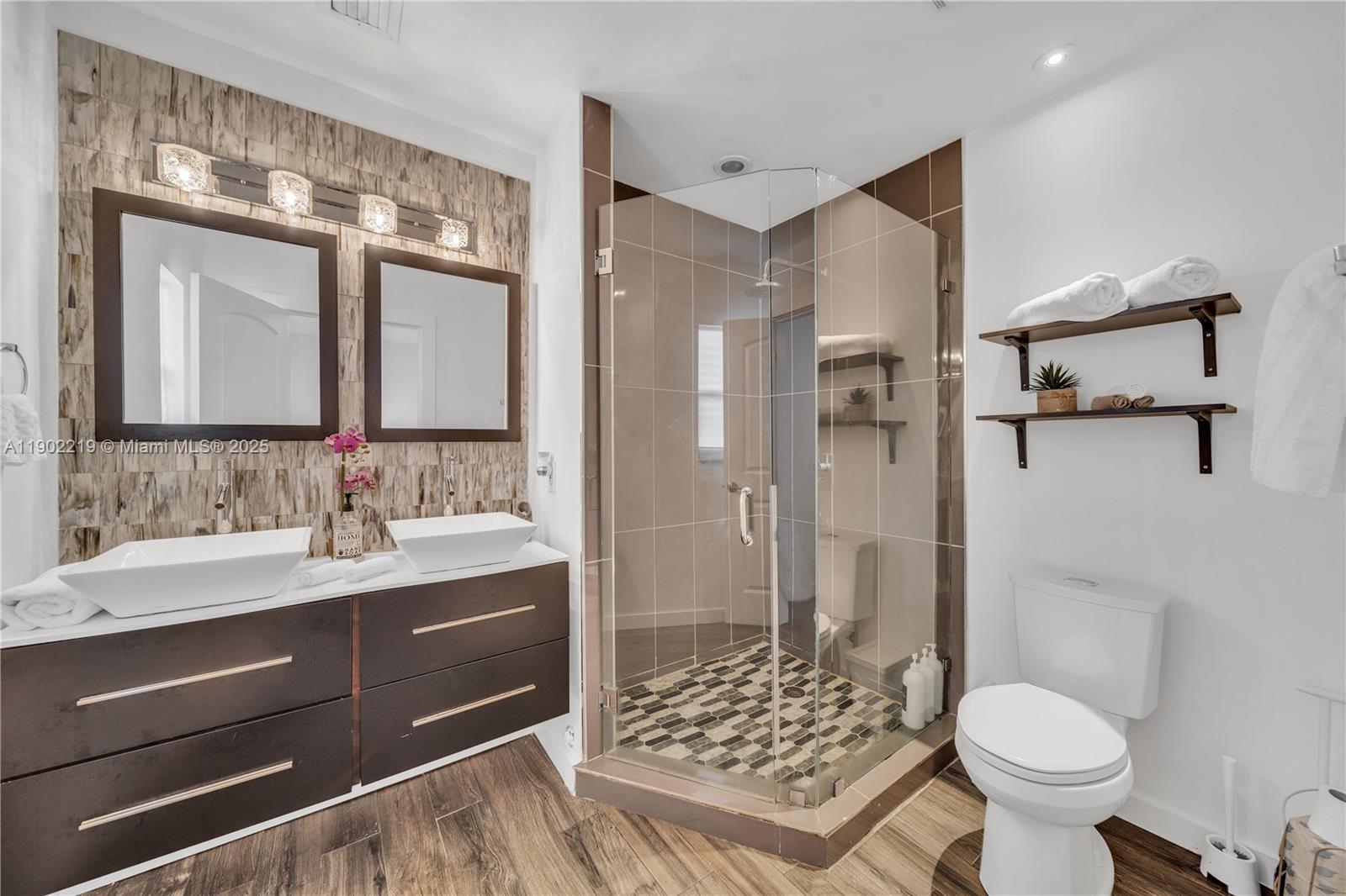 a bathroom with a sink toilet and shower