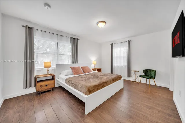 a bedroom with a bed and a desk