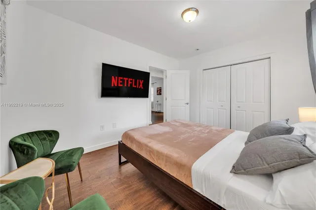 a bedroom with a bed and a large mirror