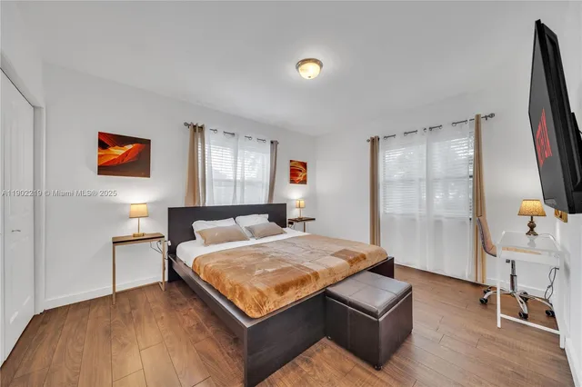 a bathroom with a granite countertop bathtub sink vanity mirror and toilet