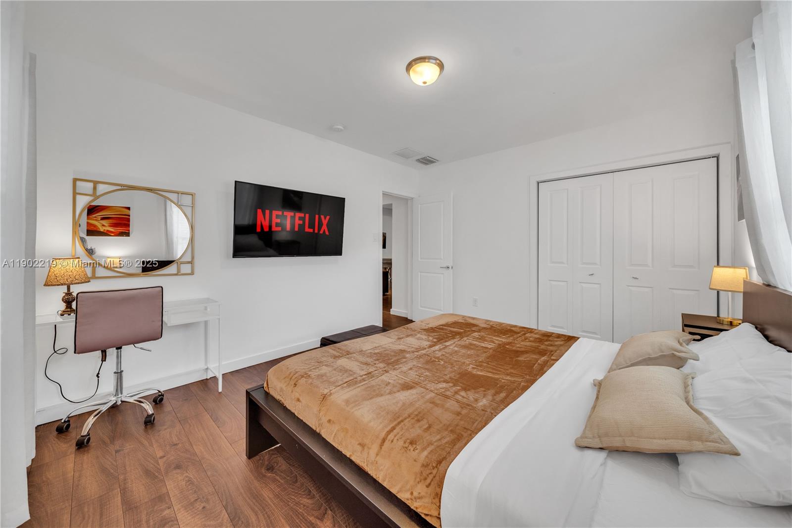 710 Northeast 141st Street North Miami, FL 33161 - Photo 23 of 78 a bedroom with a bed and wooden floor