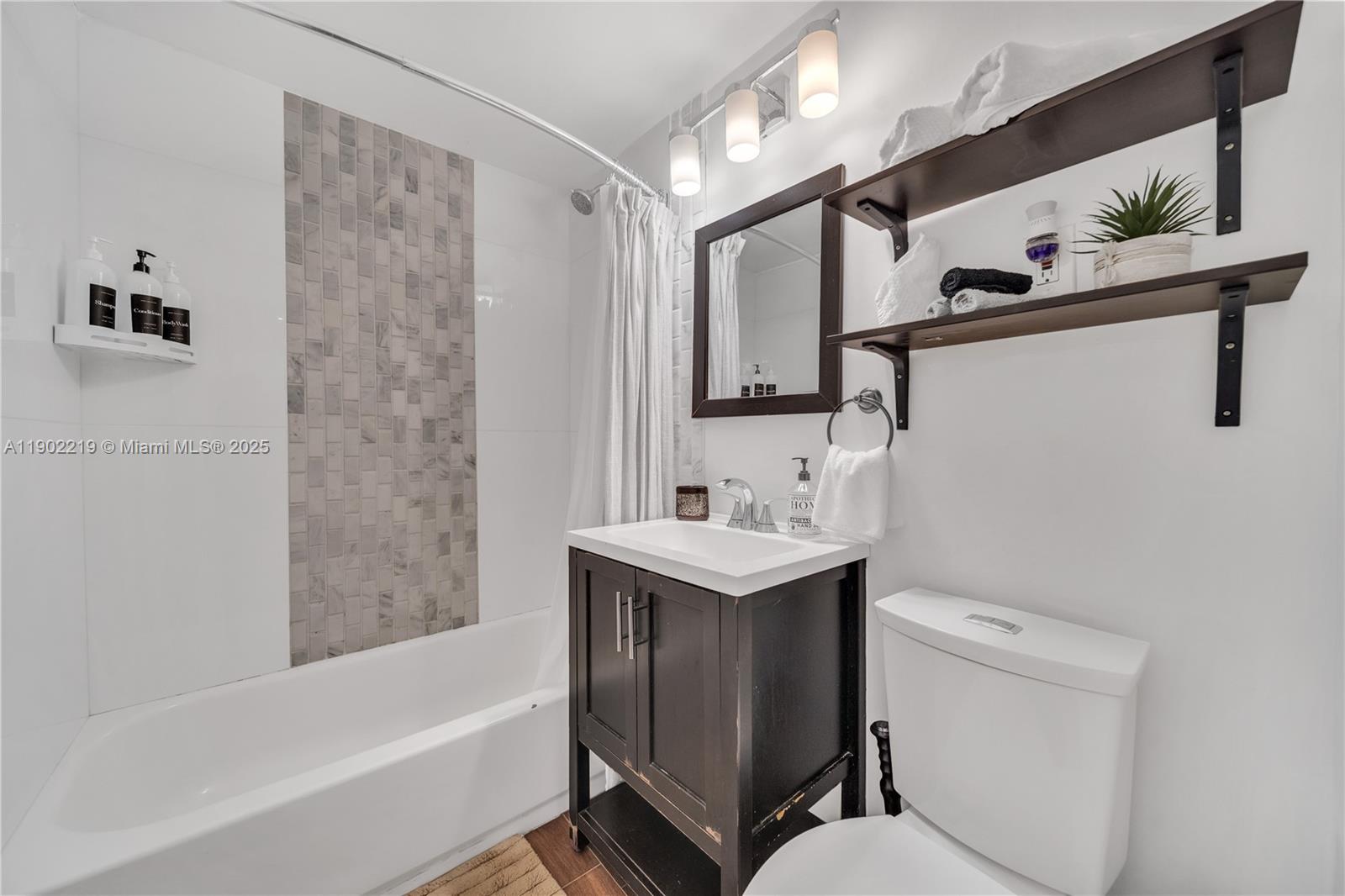 710 Northeast 141st Street North Miami, FL 33161 - Photo 24 of 78 a bathroom with a sink a toilet and bathtub