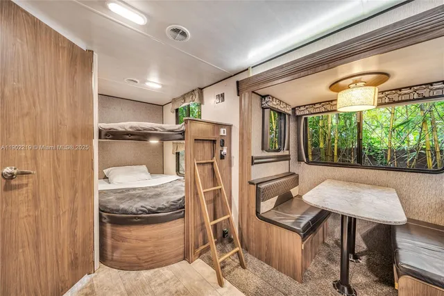 a view of a swimming pool with a table and chairs under an umbrella